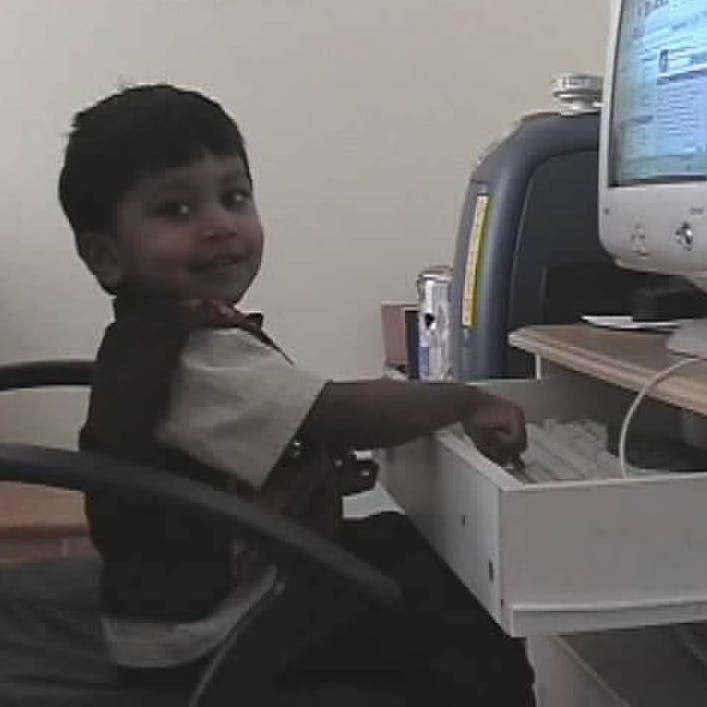 Young me typing on a keyboard and smiling